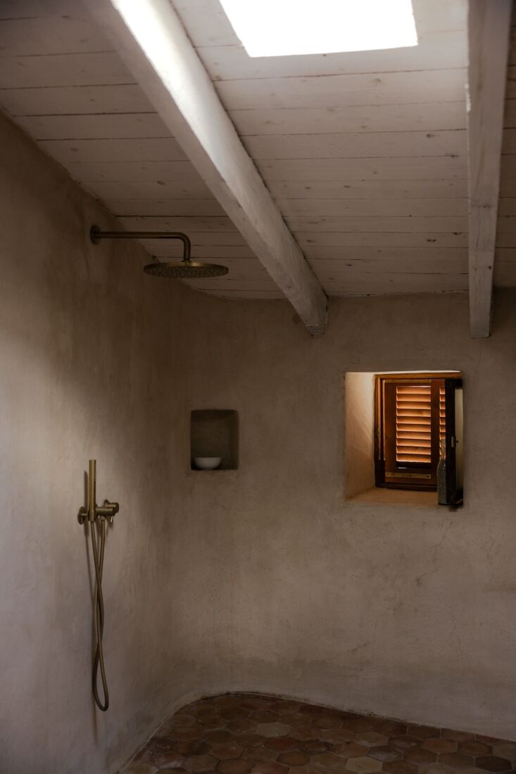 the walk in shower features mallorcan cement and salvaged hexagonal terracotta 30