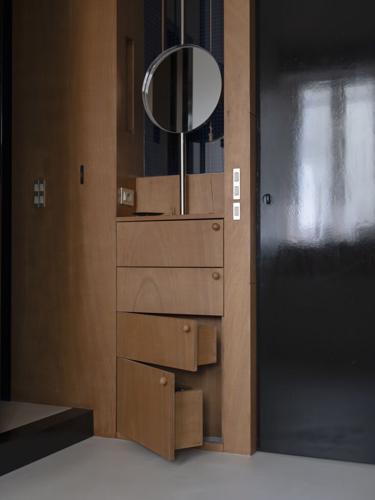 set in front of the glazed partition, saba’s bespoke vanity has pivoting draw 30