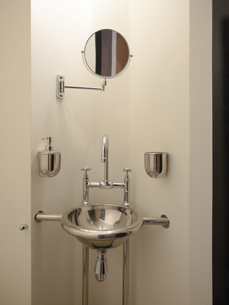 in a niche by the entrance, the basin and tap rest on a bespoke stainless steel 28