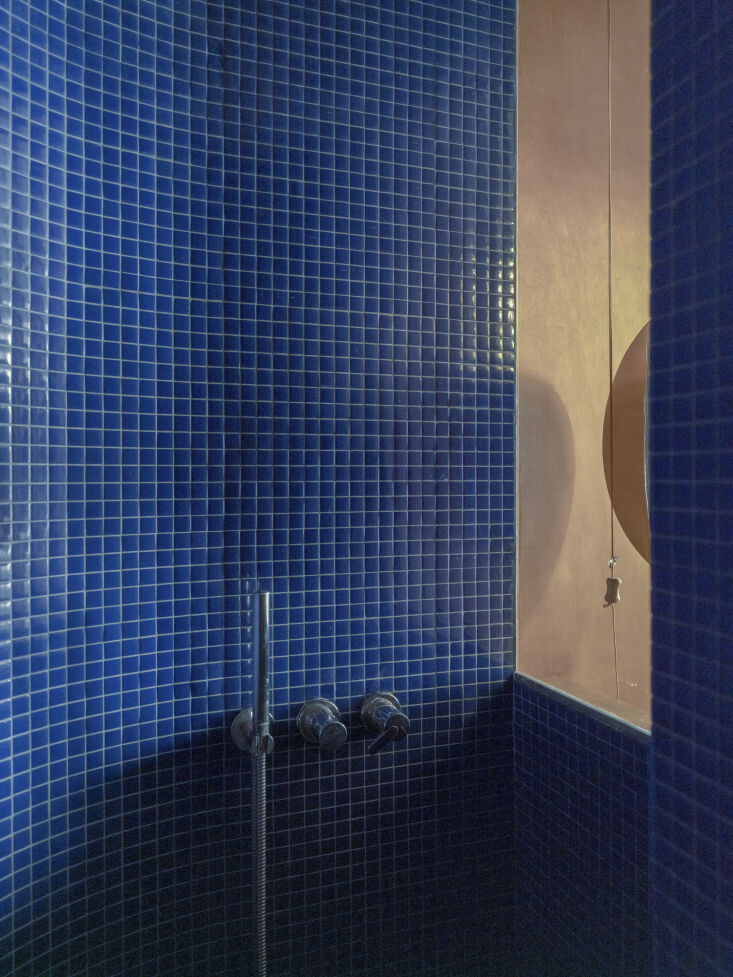 the nearly \10 foot high shower is lined from floor to ceiling in deep blue gla 27