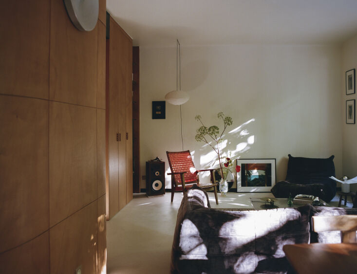 the characterful living room is designed with plum colored velvet, deep orange, 20