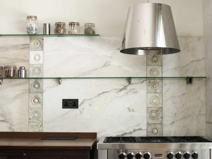 salvaged marble panels are combined with a collection of fireplace roundels—a 23