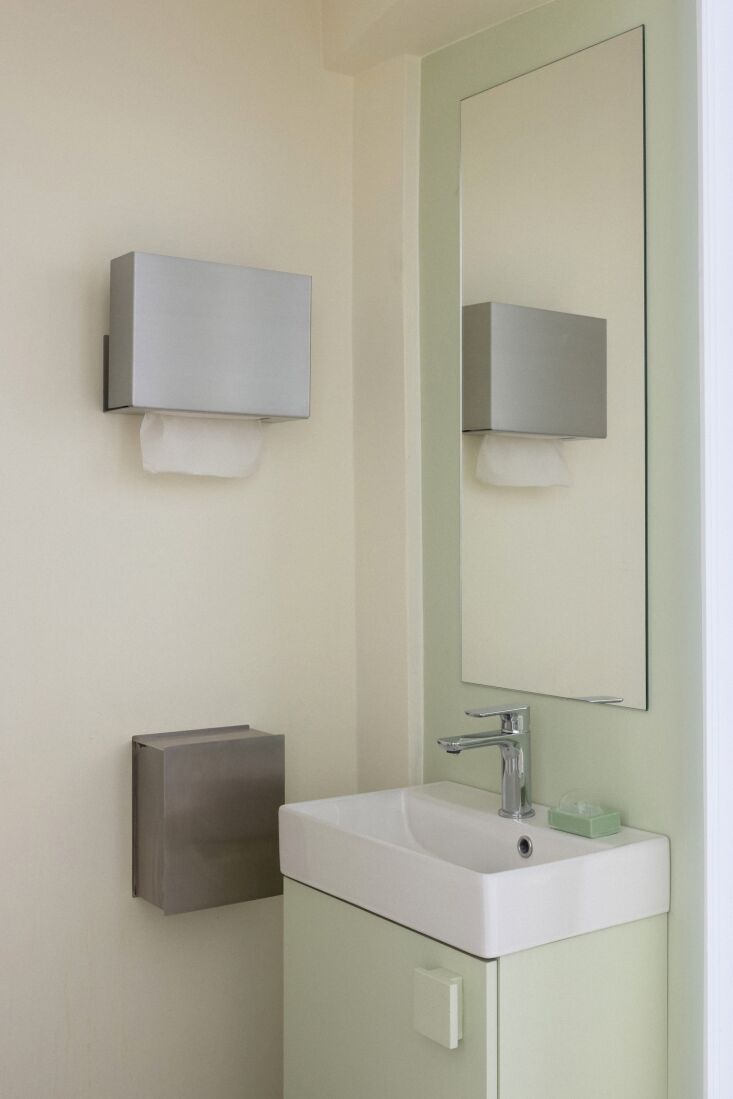 an outsized version of the block handles appears in the restroom, and the paper 26