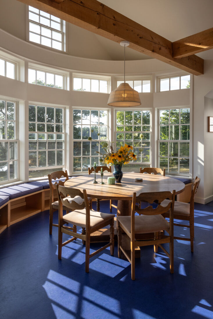 in the bright dining room, a table by bicyclette in maine is surrounded by vint 21