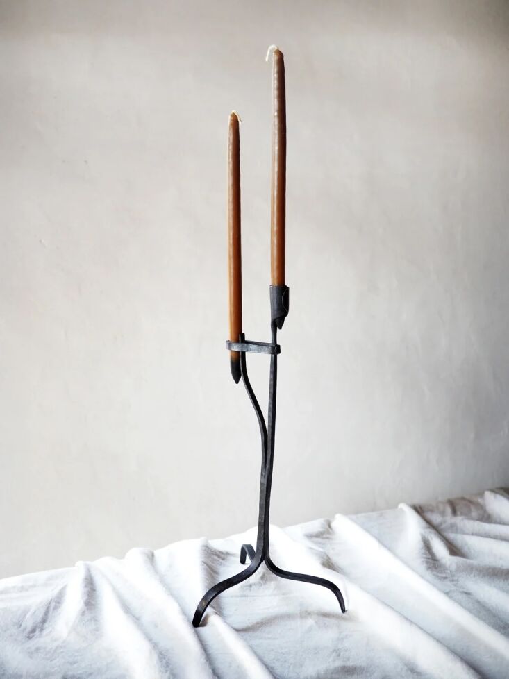 French-made and hand-forged, these shapely iron candle holders are based on the ancient rushlight, \2\20;the rural ancestor of the candlestick.” Shop now.