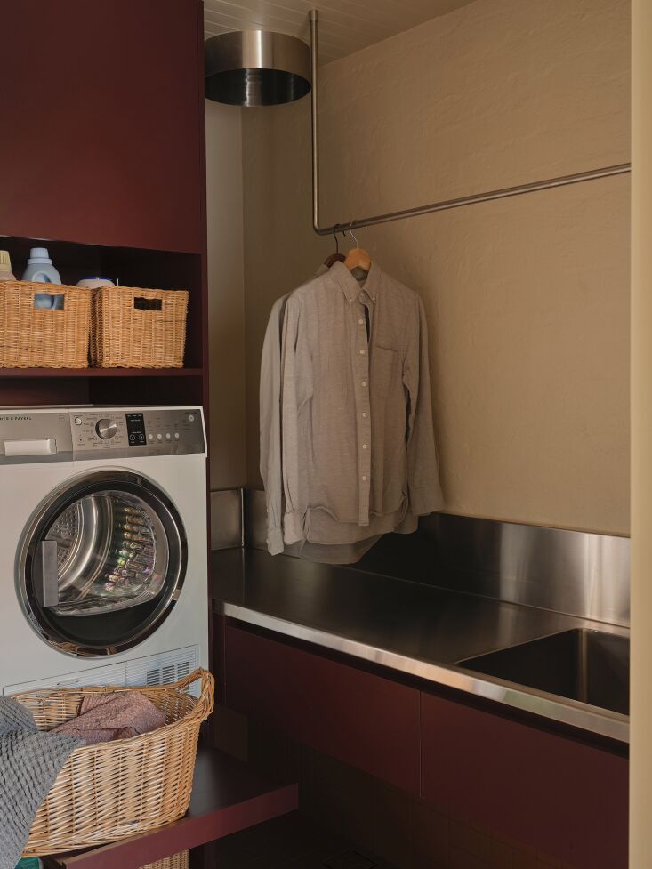 the laundry room is also on the first floor. the round metal laundry chute on t 25