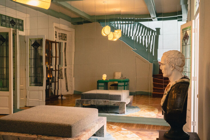 the reception room at pensión features a linen pendant light by marrow project 21