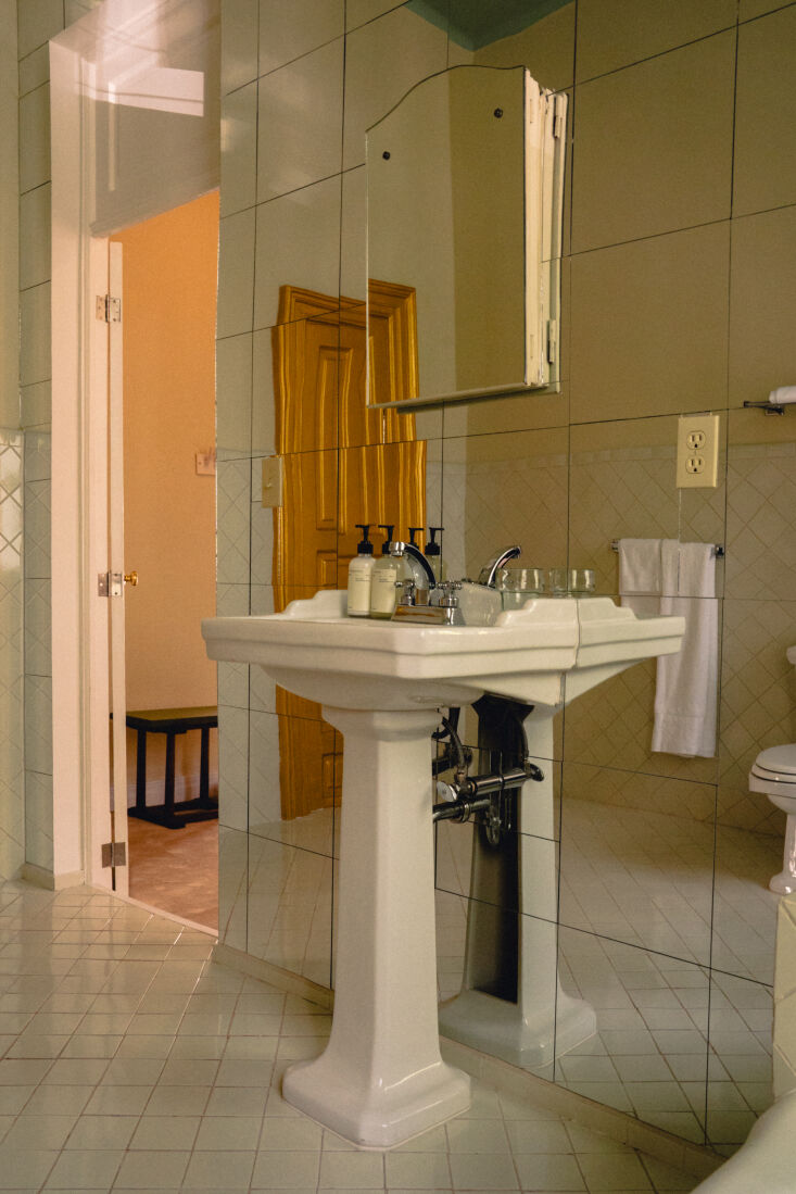 a guestroom bathroom with an original porcelain sink. when asked about the proc 24