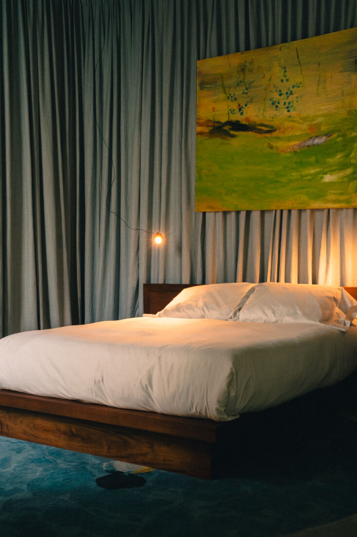 a warm and inviting guestroom with a rug from prieto’s swimming pools collect 23