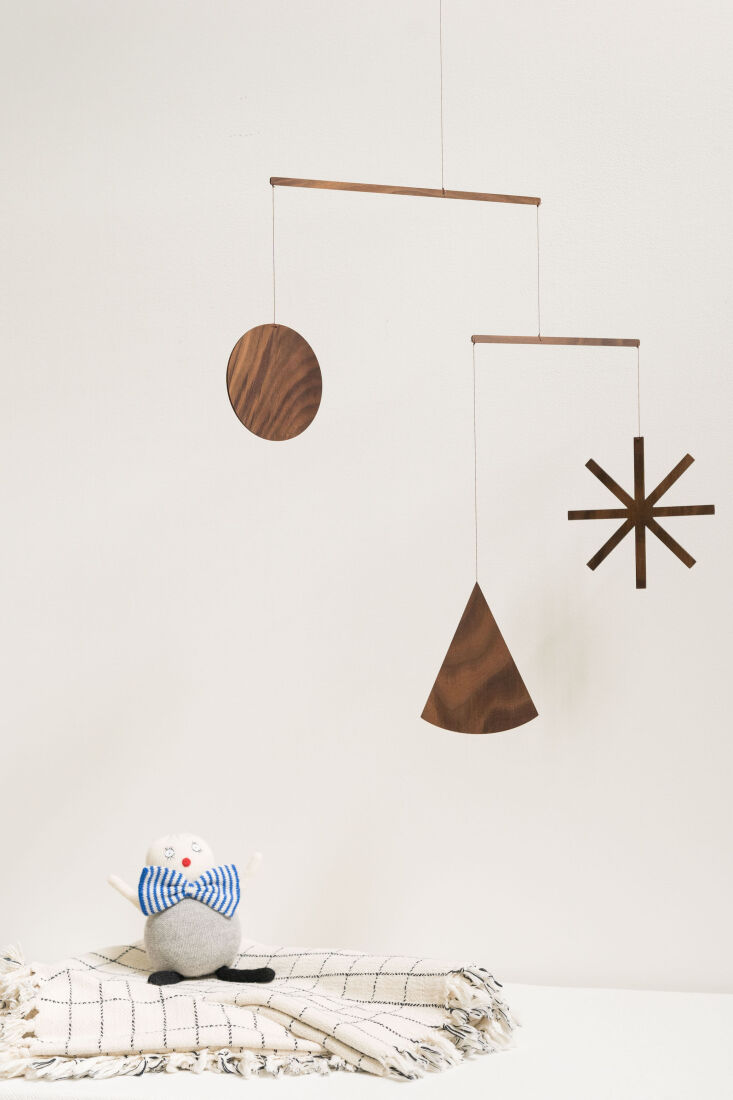 the harper mobile, $150. heather hand sands the laser cut walnut shapes and f 15
