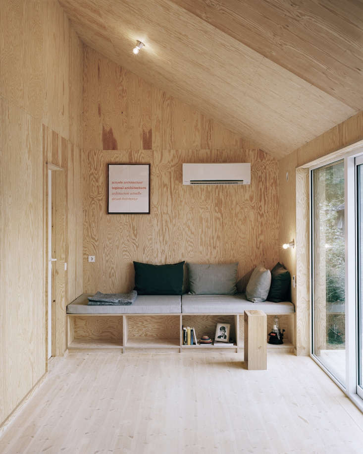 plywood panels of various types and grains line the sitting room in archit 14