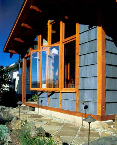 alaskan remodel: hand joined timbers entirely frame the new front facade of the 14