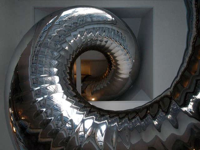 slide emerging from library ceiling: the slide coils down from the bedroom leve 18