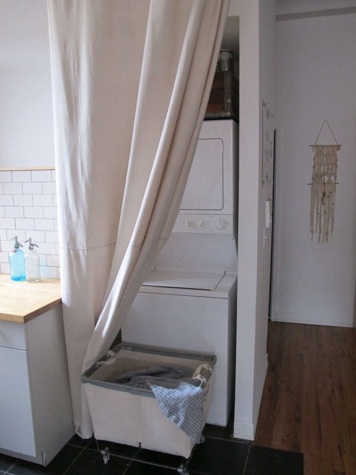 a drop cloth becomes a curtain to conceal the washer/dryer in a small apartment 17