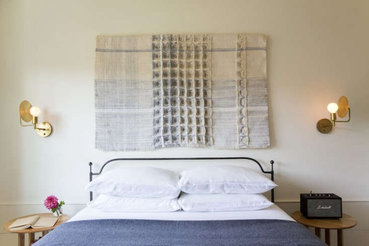 flag, a waffle weaving by hiroko takeda, hangs in a guest room at the rivertown 13