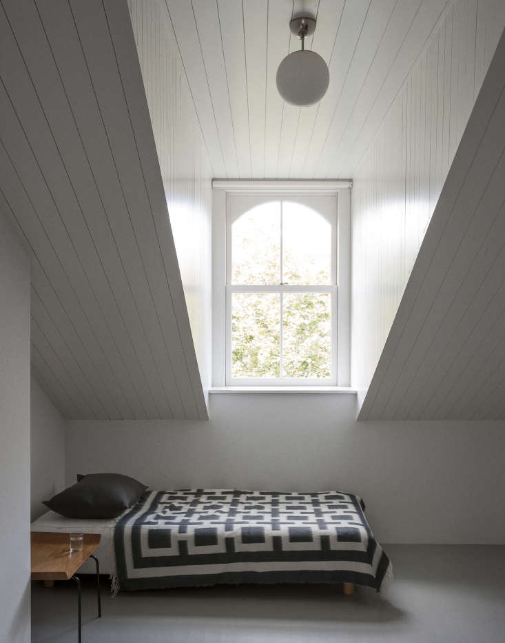  a black and white wool blanket in an attic room by architects solveig fernlu 14