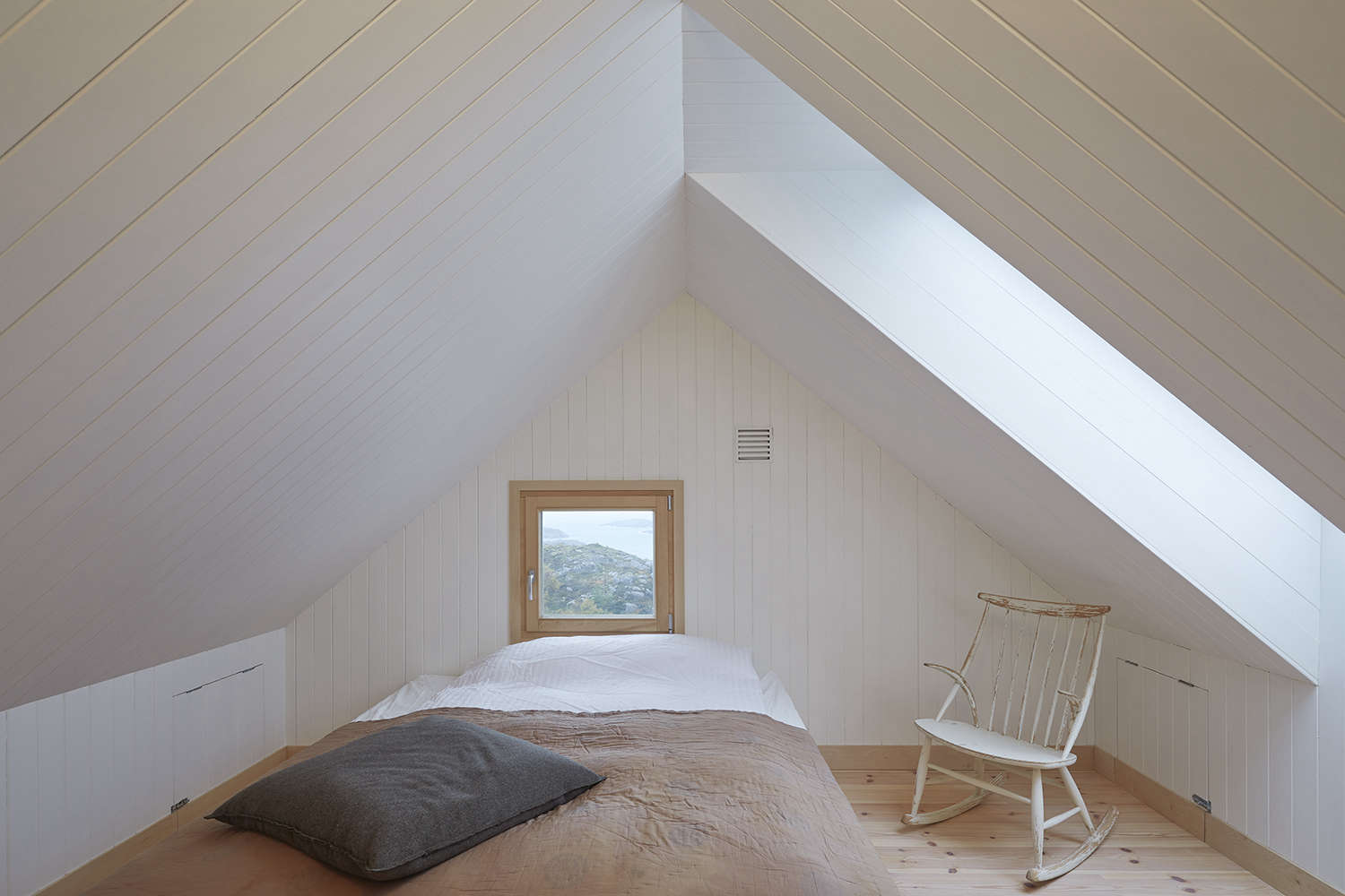 a minimal bedroom, decorated in earth tones, is flooded with nat 17