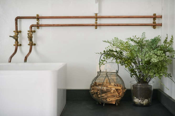 old fashioned copper taps in a historical house reimagined for a modern family 12