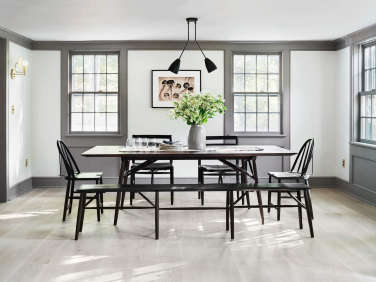dining room in modern farmhouse renovation with wood floors sawkille black furniture  