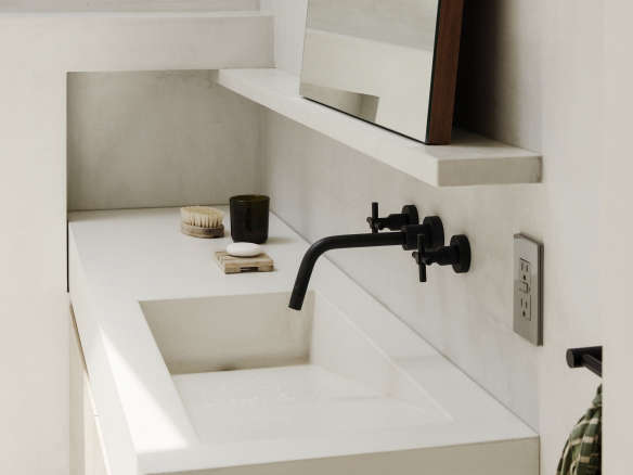 white concrete bathroom with black faucet  