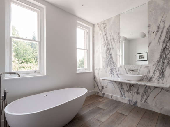 white gray marble slab wall modern bathtub wood tile floor  