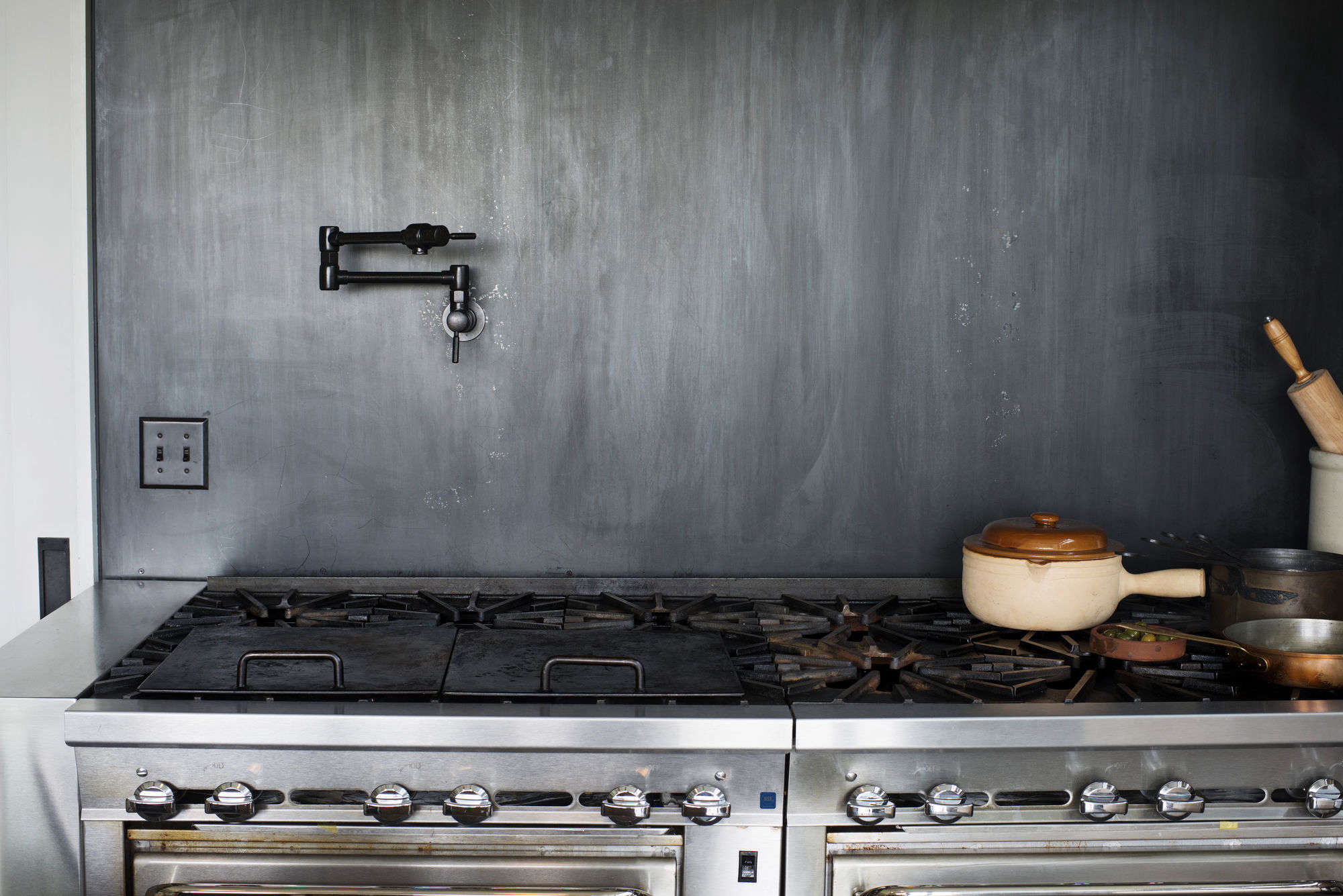 a backsplash made of blackened, cold rolled steel and a brizo (62820lf)  18