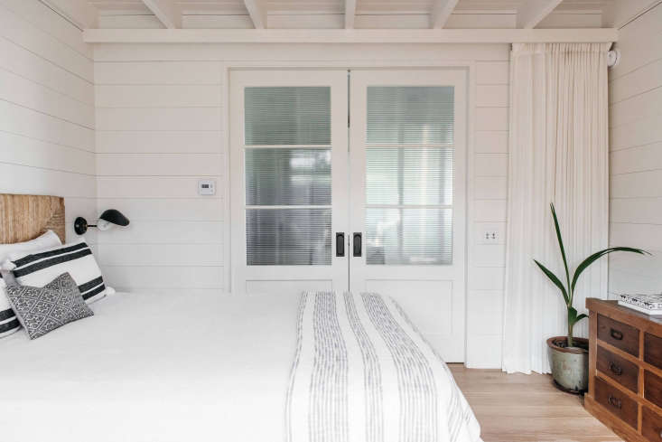 in a bedroom, white curtains pull across double sliding doors for added privacy 18