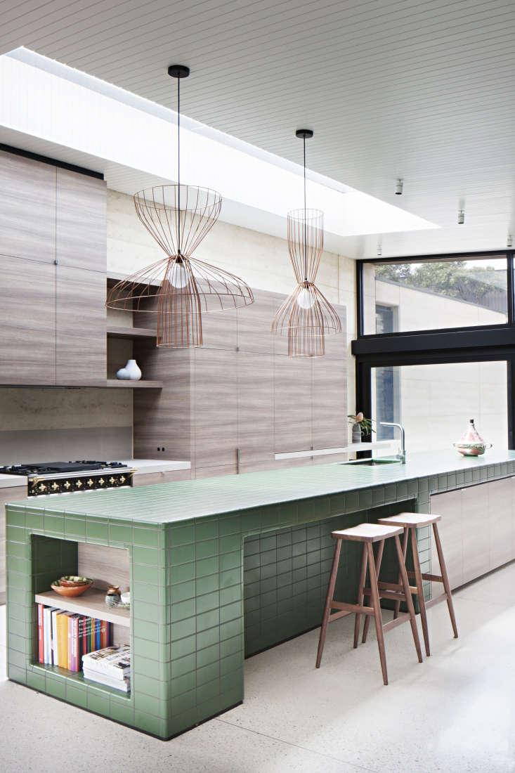 this extra long kitchen island is covered with green tiles sourced from melbour 17