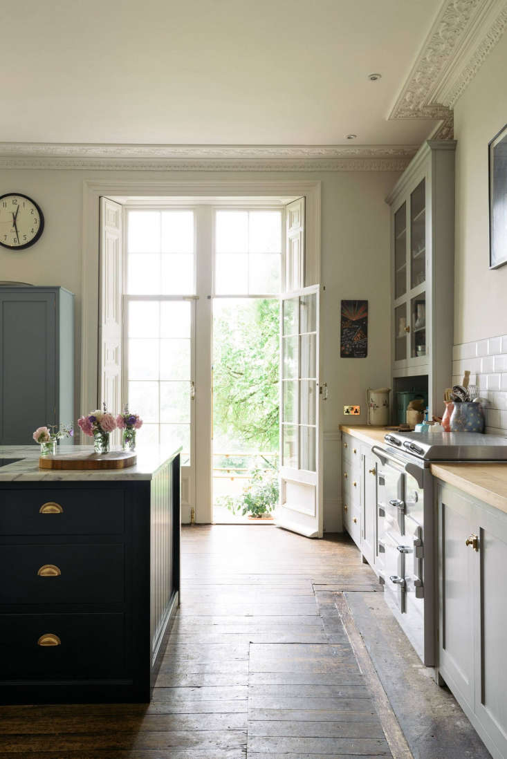French door leading to patio in English Country kitchen by deVOL