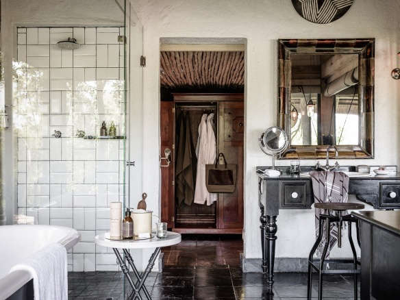 singita ebony lodge open plan bathroom tiled walls antique safari  
