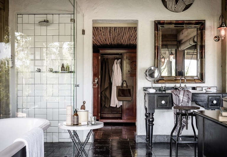 singita ebony lodge open plan bathroom tiled walls antique safari  