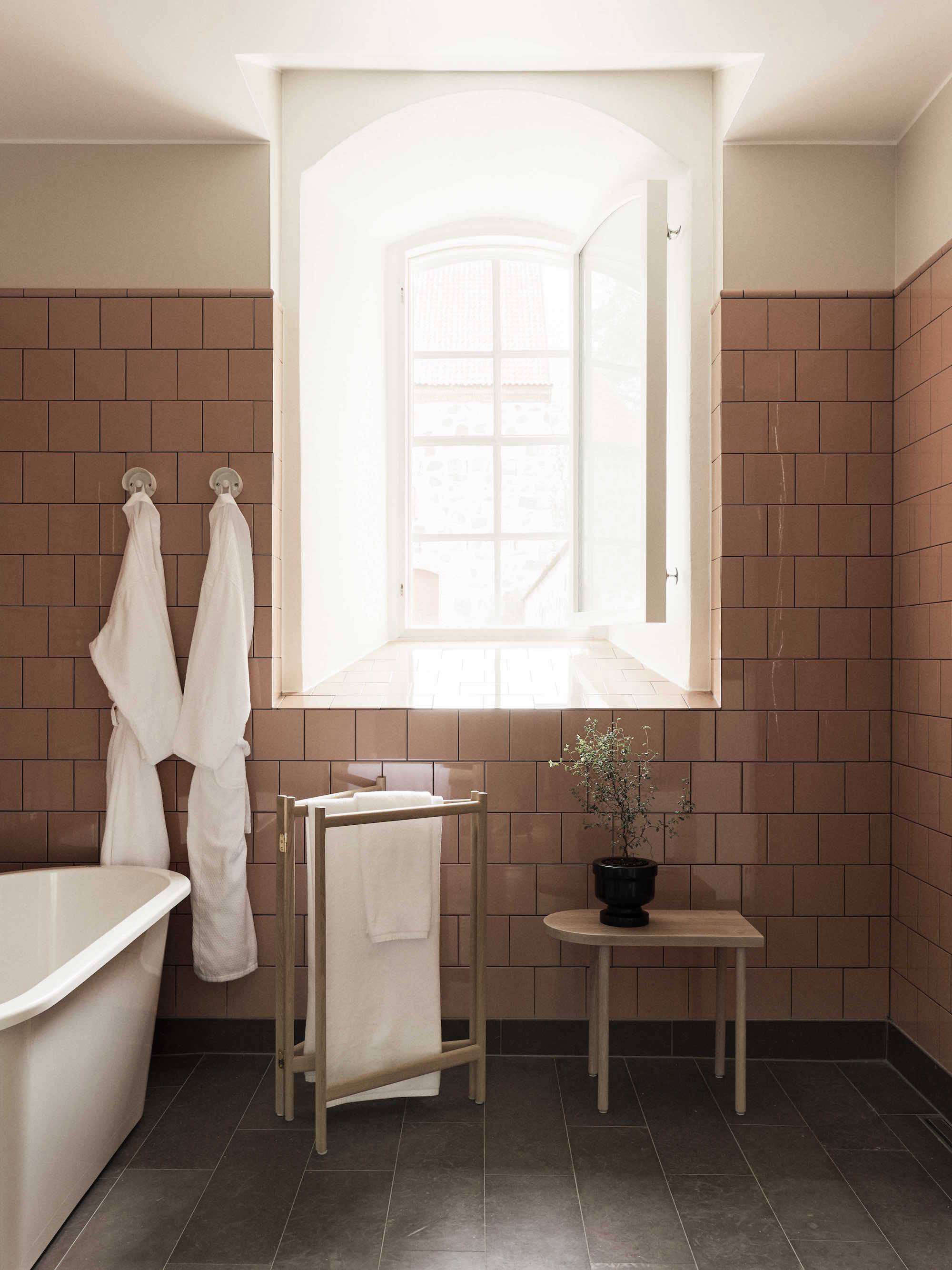 the bathroom is finished with vintage pink square tiles, ifö bath fixtures 12