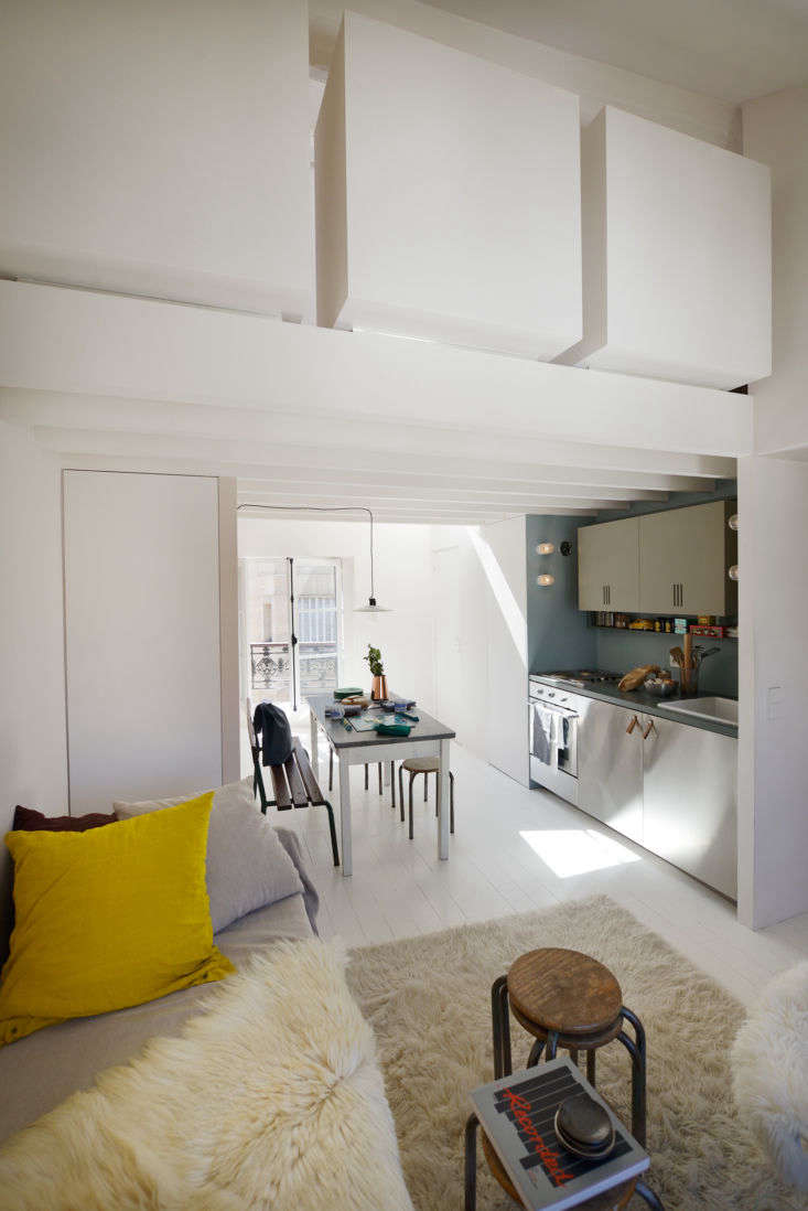 the front door opens to an all in one living space. those floating white square 17