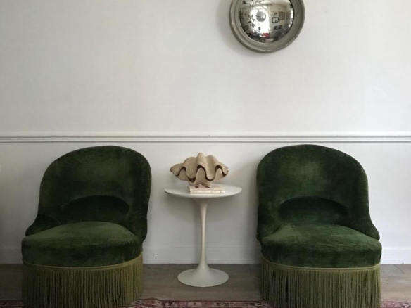 pair of low fireside chairs green fringed nomibis france cropped cover    