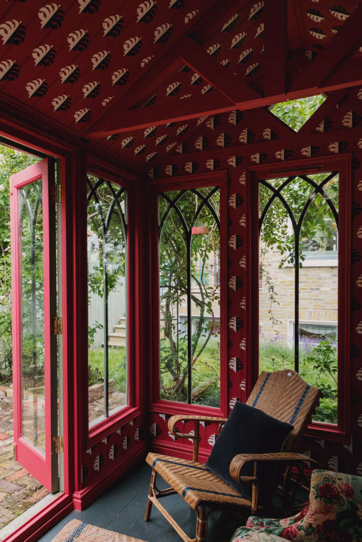 hand painted red patterned walls in the garden pavilion of designer of the mome 9
