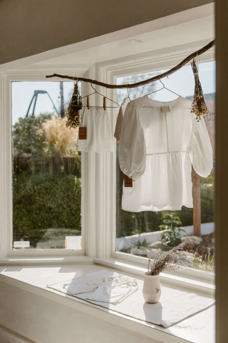 in the front window, a curved branch displays a rudy jude day blouse—and 18