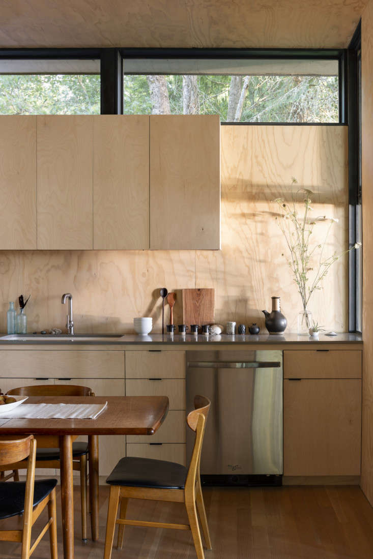 the kitchen is clad entirely in plywood, with custom cabinets. at right, above  10