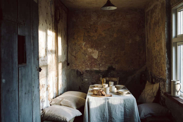 exposed, stripped back walls stand in lieu of wallpaper or paint. here, a dinin 15