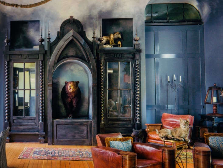 the great room is filled with curiosities, including a taxidermy bear and bobca 10