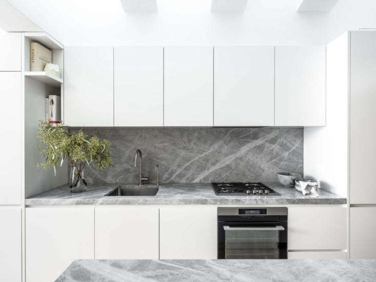 savoy light marble was used for both the counters and blacksplash for uniformit 17