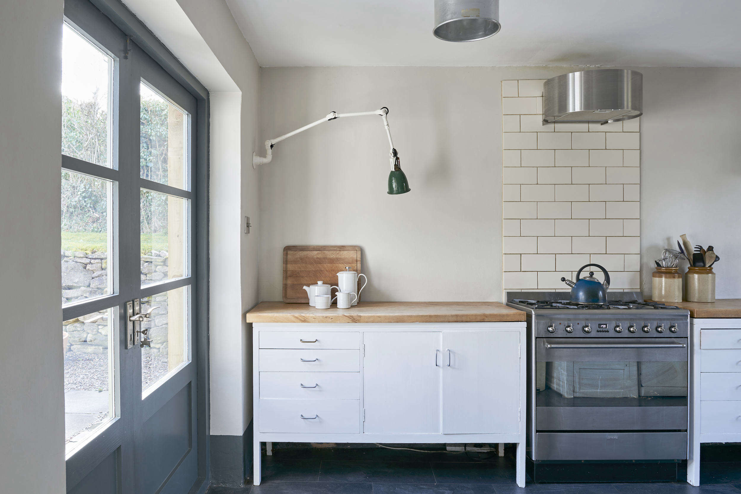 the freestanding smeg range is anchored with a strip of subway tile as a backsp 9