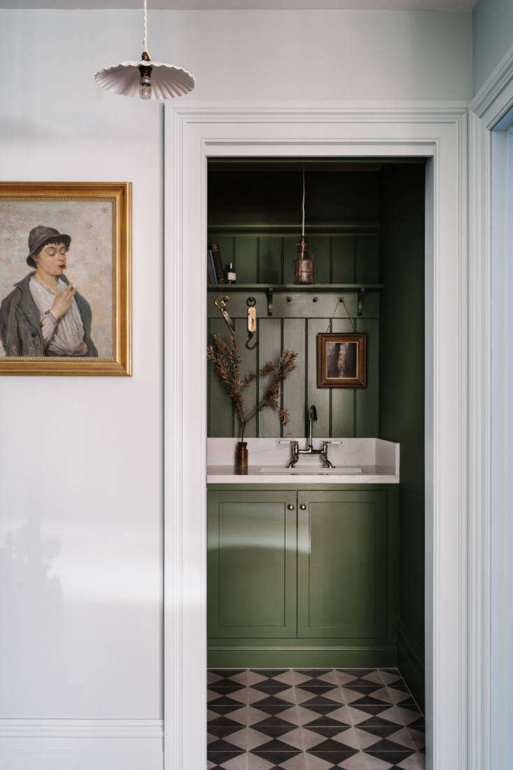 nearby, a utility room is painted in green velvet by porter’s paints (ce 14