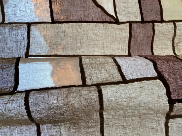 a closeup; the landscape is visible through lighter, thinner pieces of cloth. & 10