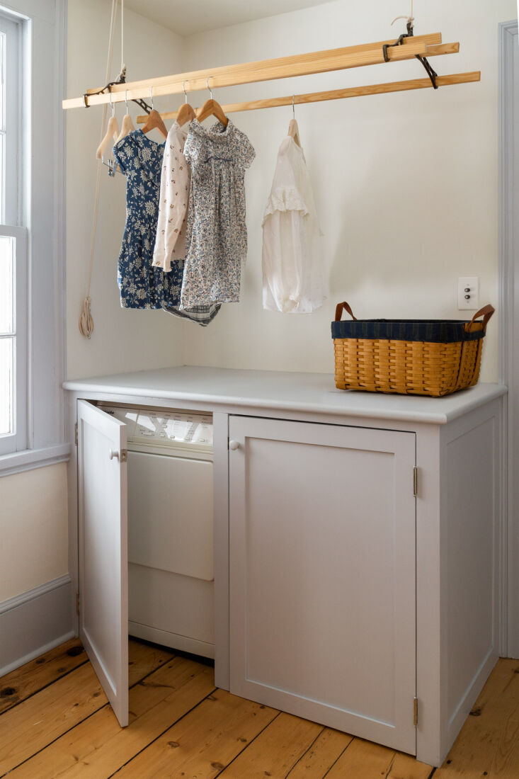 the laundry room features a hanging drying rack and clever built ins. but what  10