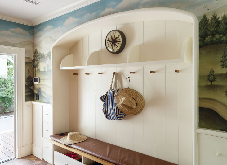 the mudroom features a pastoral mural (actually wallpaper by gracie, purveyors  11