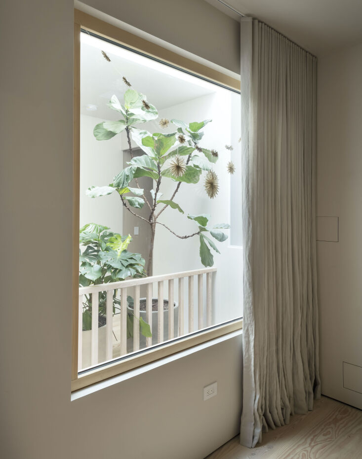 a by mölle linen curtain covers the window wall in the baby&#8217;s  31