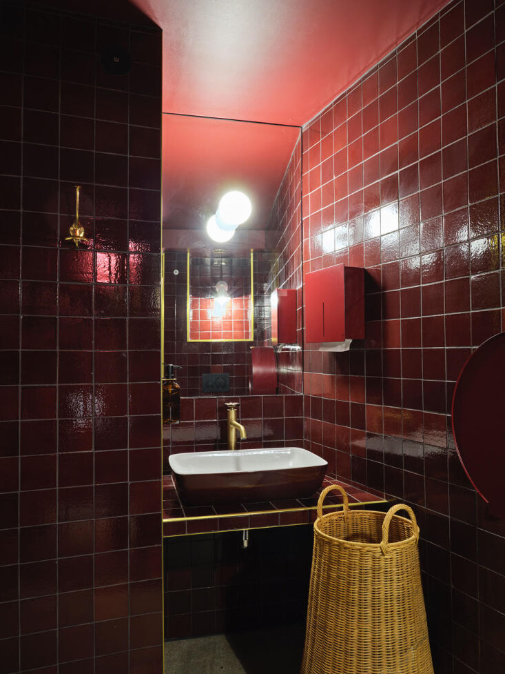 the bathrooms shift to dramatic glossy tiles in a claret red from fifth generat 21