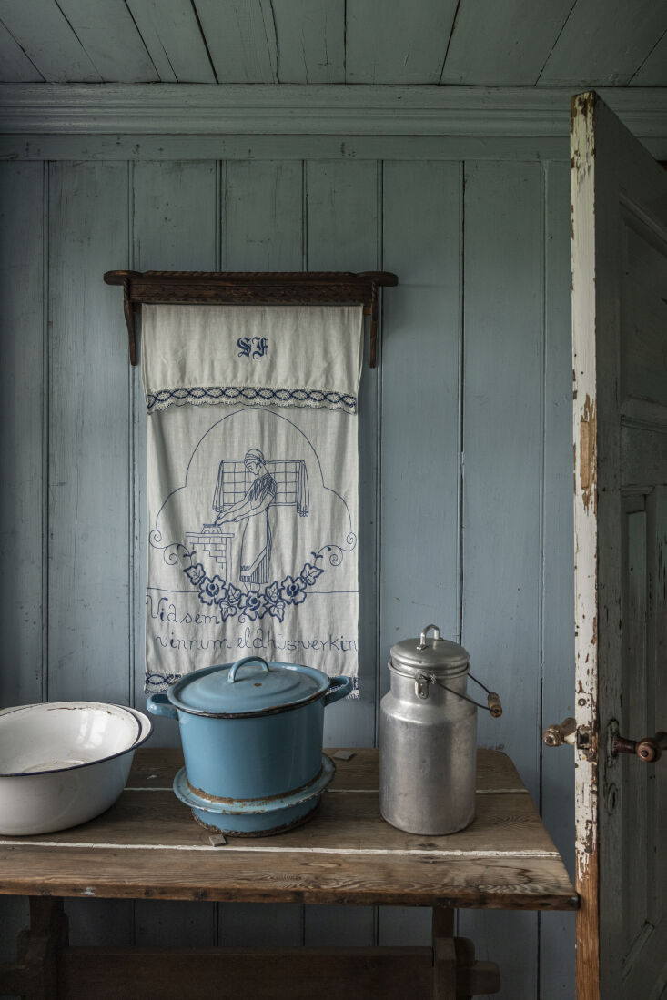 a wall mounted dowel keeps a hand embroidered tea towel readily available. (the 15