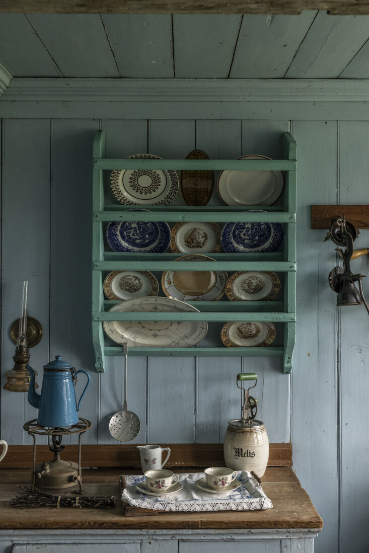 a wooden wall mounted plate rack is painted in teal for a tone on tone effect i 13