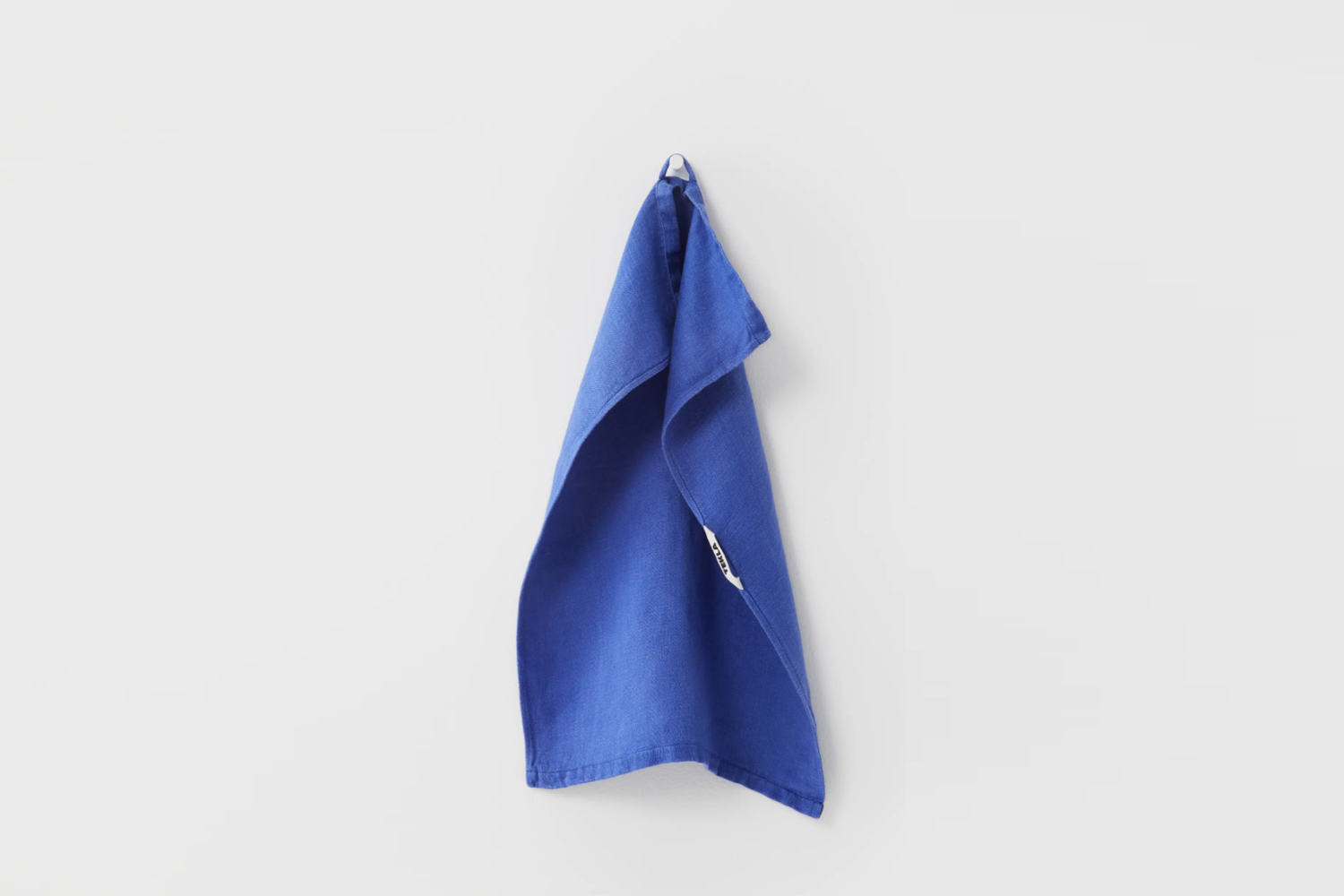 the linen tekla kitchen towel in stain, a deep blue color, is $45. 23